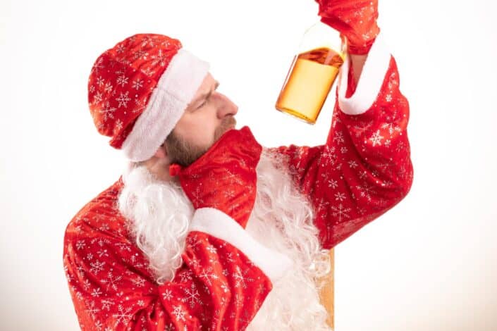 santa claus looking at a half filled bottle