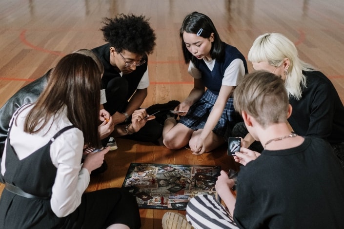 group of friends playing a card game