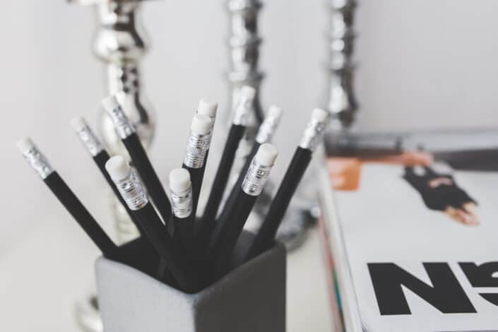 bunch of black pencils in an pencil holder
