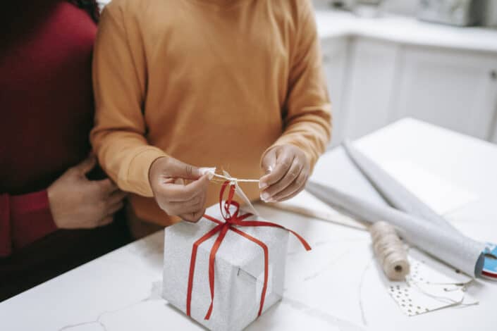 person wrapping a gift
