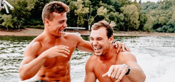 Two men laughing while swimming