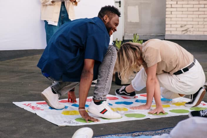 Man and woman playing outdoor twister