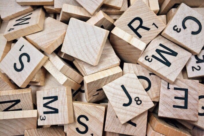 A pile of lettered scrabble tiles