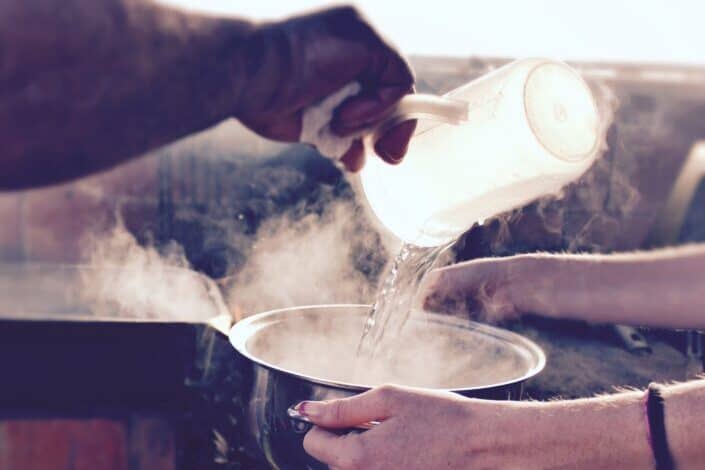 Boiling water being poured in a container.