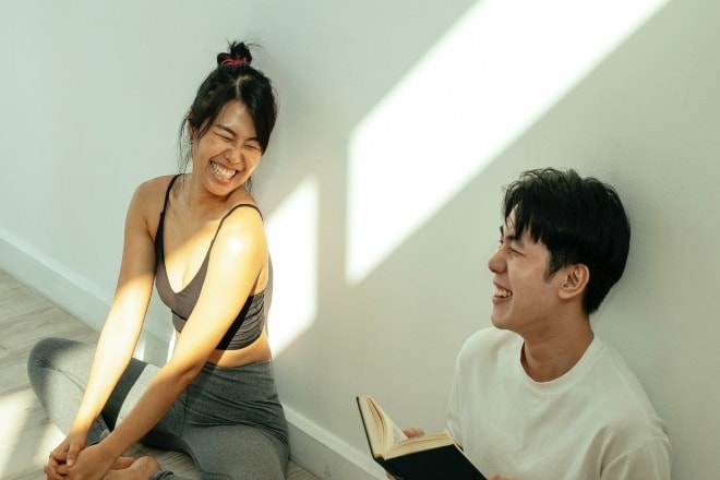 A couple laughing by a wall - Flirty Knock Knock Jokes