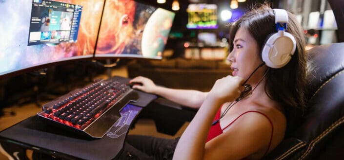 A game streamer in front of her sophisticated gaming setup