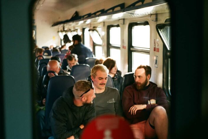 Men Sitting in a Bus and Chatting