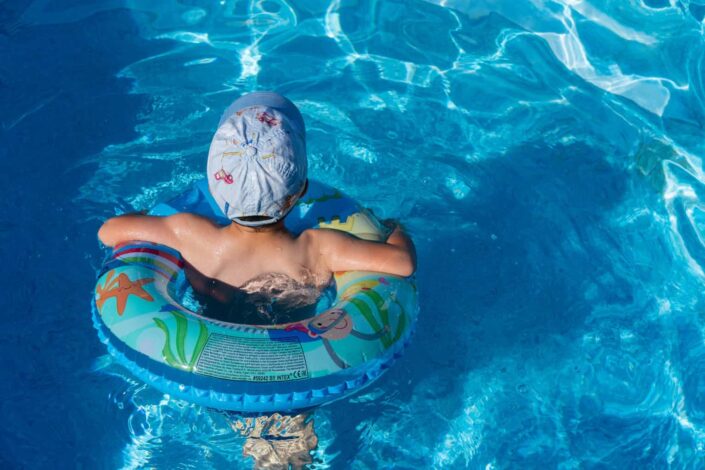 Boy wearing cap in a swimming pool