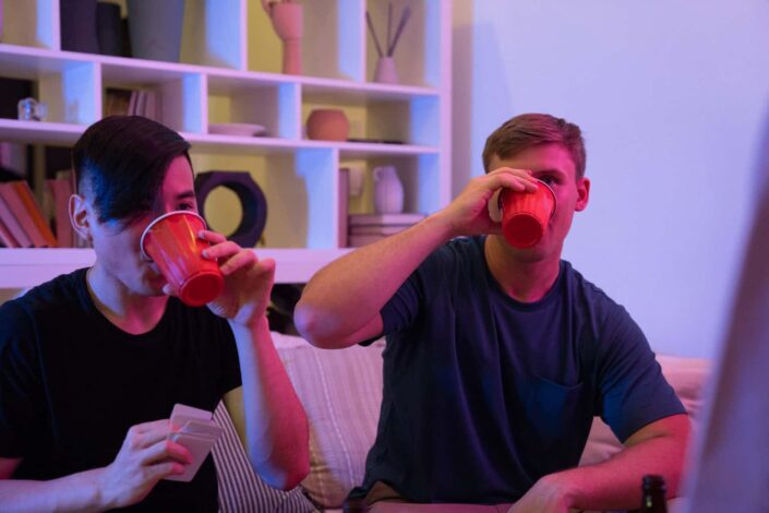 Men Drinking From Red Disposable Cups
